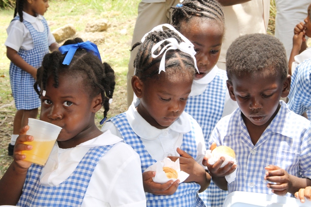 Students of the Charlestown Pre School sampling hot bread and butter baked in a traditional stone oven at the Nevisian Heritage Village at Zion Village on May 05, 2016, at the Ministry of Tourism’s Nevisian Heritage Life event